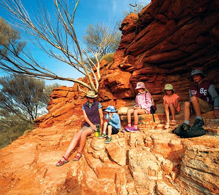 Family having a break from hiking at the King's Canyon Rim Walk, NT