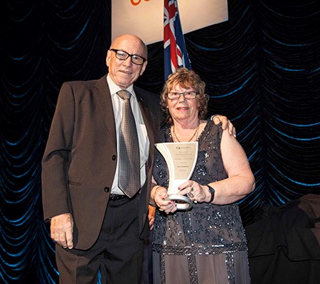 Caravanning Queensland chief executive Ron Chapman was presented his award by Margaret Davis. 