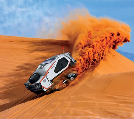 Track Trailer in the desert driving through sand dune