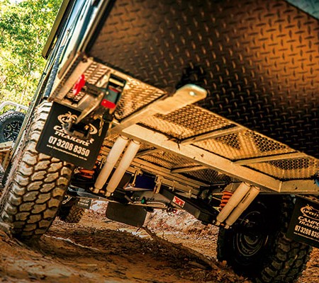 Towing camper trailer offroad in the mud