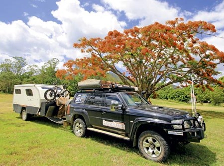 Camper trailer under a beautiful poinciana tree