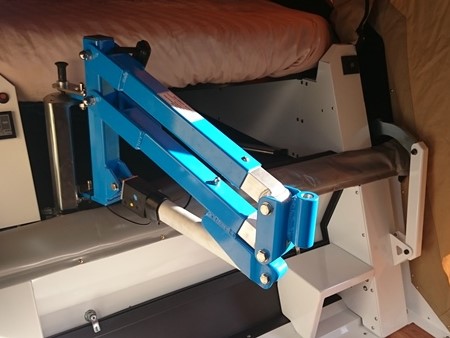 A remote-controlled hoist allows movement from a wheelchair to the bed in this Pioneer Camper.