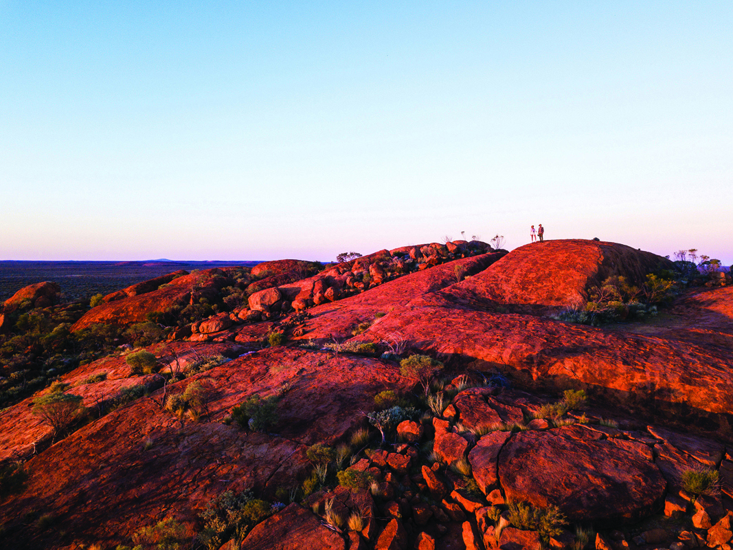 Two people standing on a rock formation