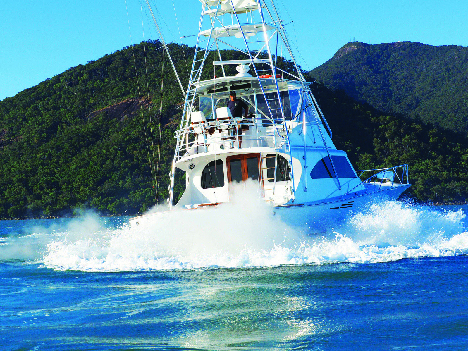 Man standing on middle deck of boat