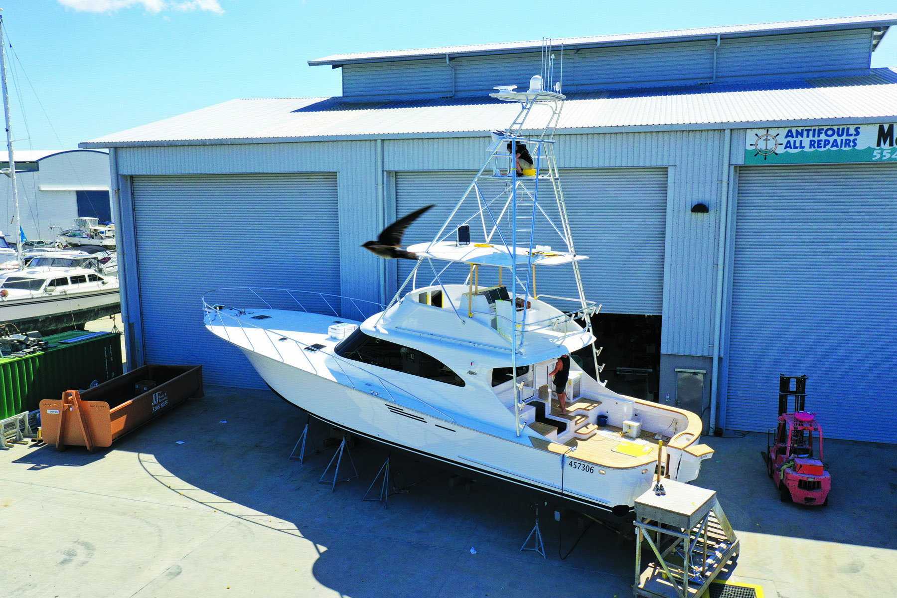 Boat sitting outside of a shed